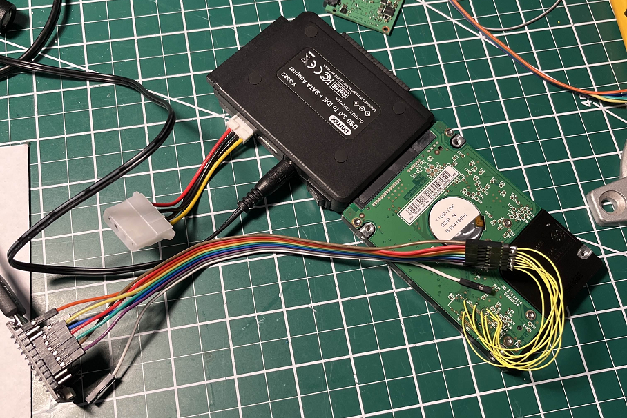 JTAG debug wires soldered to unpopulated MICTOR connector pads on Western Digital HDD circuit board for hardware debugging