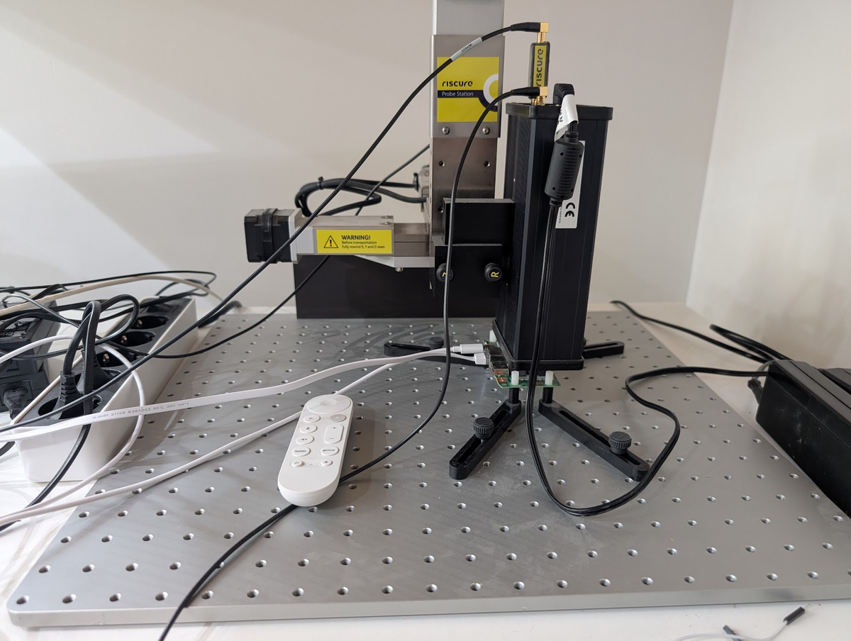 Physical EMFI lab setup showing Keysight equipment and Google TV Streamer